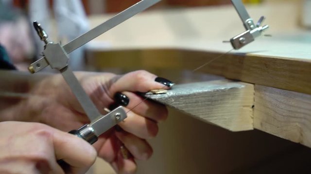 Jeweler makes a piece of jewelry - golden wedding ring