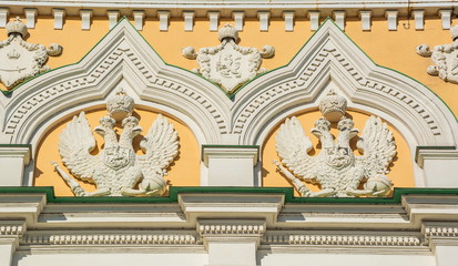 The bas-reliefs with  image of double-headed eagles adorn  facade of  old building.