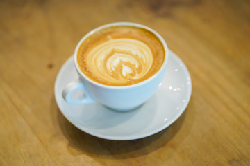 Cups of latte art on wooden table background, Top view.