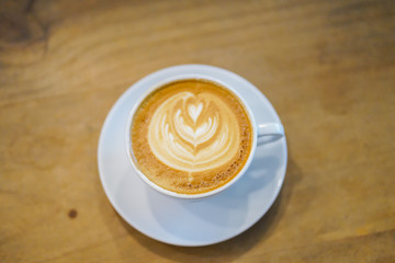 Cups of hot latte art on wooden table background, Top view.