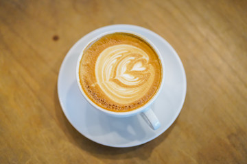 Cups of hot latte art on wooden table background, Top view.