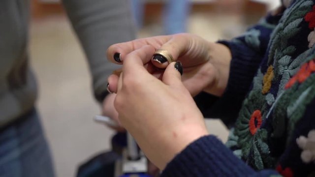 Jeweler makes a piece of jewelry - golden wedding ring