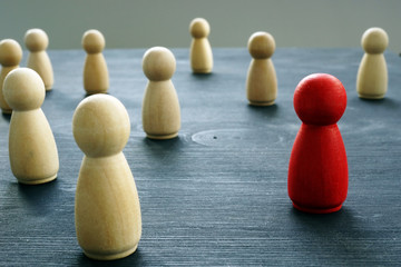 Crowd of figurines with red one. Uniqueness and Individuality.