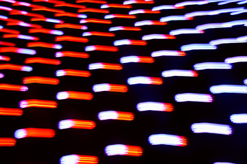 Long exposure photo of moving colorful neon light patterns