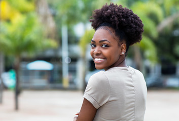 Smiling caribbean woman with afro hair