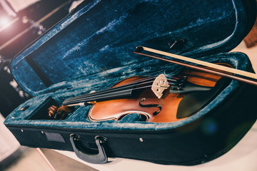 Violin on its case. Blue velvet violin case at music store