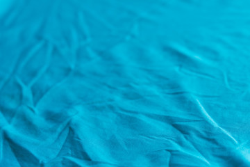 blue creased textile selective focus background