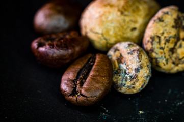 Brown roasted coffee and cocoa beans on black background, close up, macro
