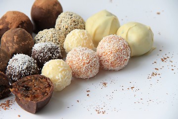 Round chocolates are on a white background.