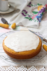 Traditional Romanian or Moldovan corn pie malay, with icing on a light background. Rustic style.