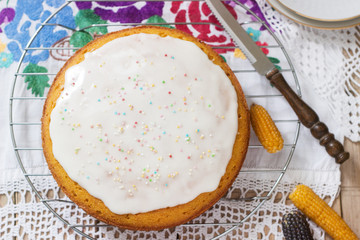 Traditional Romanian or Moldovan corn pie malay, with icing on a light background. Rustic style.