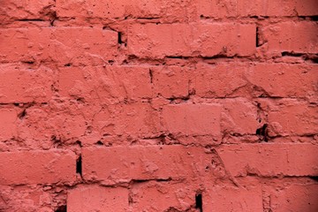 Bright red brick wall with plaster