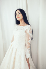 Bride in a wedding dress in the fitting room. The concept of wedding dresses and preparation for marriage.