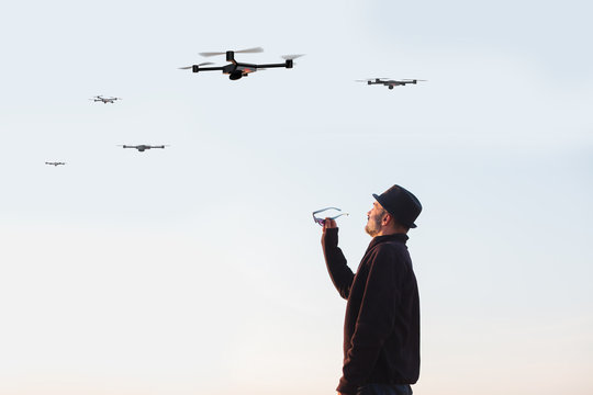 man looking at the sky filled drones drones