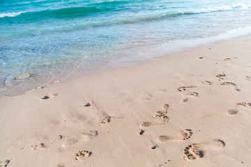 Footprints on empty sandy beach