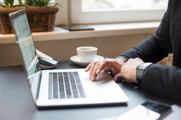 businessman working on laptop in office taking notes