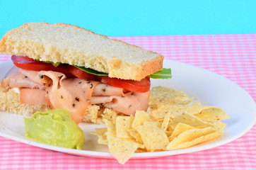 Peppered Turkey Breast Sandwich with Tortilla Chips and Guacamole