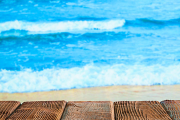 Wooden table with empty space on the beach background