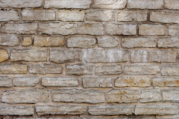 Fragment of old gray brick stone wall background