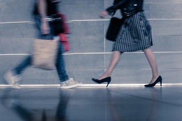 Closeup of busy people at rush hour walking on city street