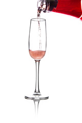 pouring pink wine into glass, isolated on white background