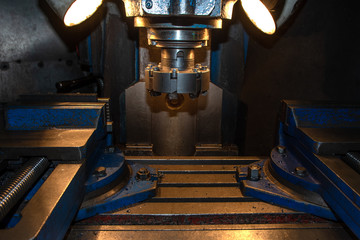closeup machine tool in metal factory with industrial drilling cnc machines