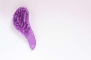 Closeup purple hairbrush for combing in period of hair fall on white background with copy space. Salon professional equipment for making hairstyle. - obrazy, fototapety, plakaty