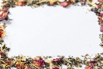 Frame with green tea with dried flower petals and pieces of citrus. Dried tea for welding. Diet and healthy drink. Free space. Flatley. Top view