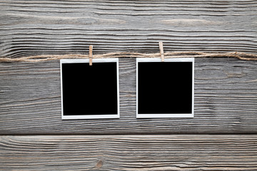 Two vintage photo frames with empty space on wooden background
