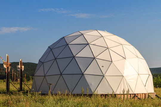 white geodesic dome on sunny summer day