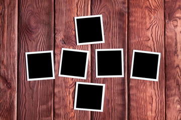 Classic photo frames on wooden board