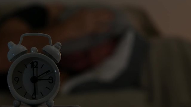 Tired Man Sleeping in Bed and Waiting Morning Clock Alarm