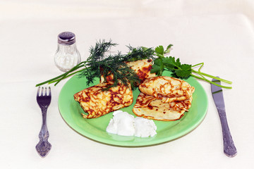 pancakes with filling on a green plate