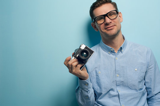 Young male photographer holding a new camera