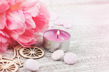 Fototapeta na wymiar Fresh pink tulip flowers and candle