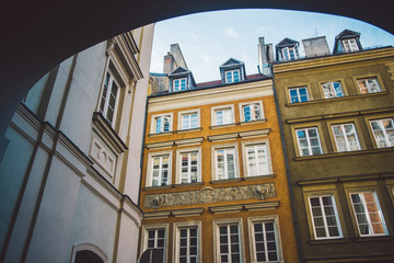 Obraz premium Old ancient polish architecture. Colorful houses as a part of center of the Warsaw. Castle with red bricks