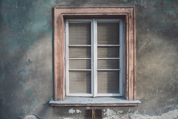 Aged european wall with wooden old-fashioned stylish window