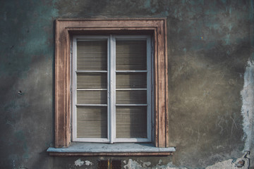 Aged european wall with wooden old-fashioned stylish window