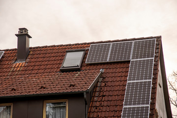 Photovoltaic system on a roof versus chimney heating in bad weather