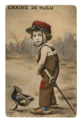 French historical postcard: A boy in a military cap with a sword on his belt pees in a German helmet-pikelhaube. world war one 1914-1918. Republic of france