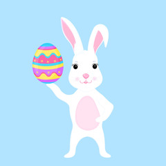 Funny easter bunny holds an paschal egg in its paw