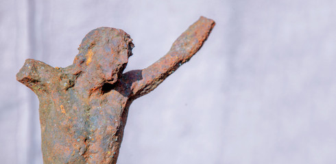 Partially destroyed ancient iron statue of the crucifixion of Jesus Christ. Faith, religion, suffering, love, God concept