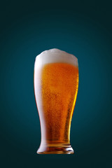 Glass of cold beer on background.