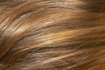 Brown hair as background, texture. One of the popular shades of hair coloring
