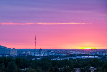 Beautiful city sunset with a sun and clouds 