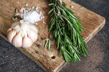 Obraz premium Fresh rosemary herb, scab and spices on a dark background copy space top view.