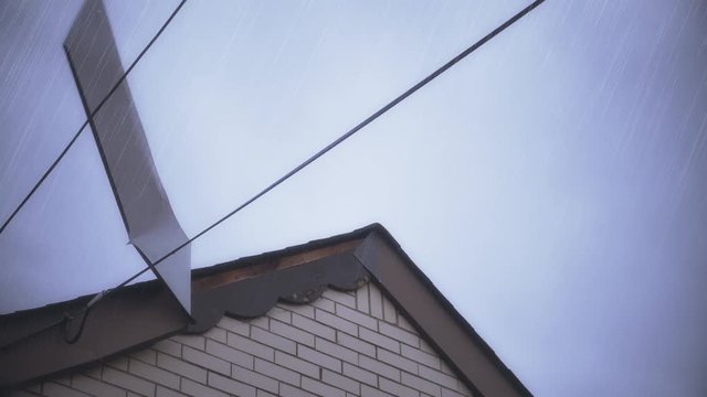 A wind storm or hurricane damages a house's flashing or siding.  	