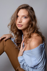 Fototapeta premium Stylish look of a sexy woman in a blue shirt. Street style studio photography. Model test