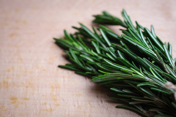 Fresh rosemary grass on a light board top view copy space