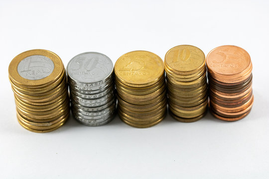 A super macro image of a pile one real, fifty, twenty five, ten and five cents isolated on a white background